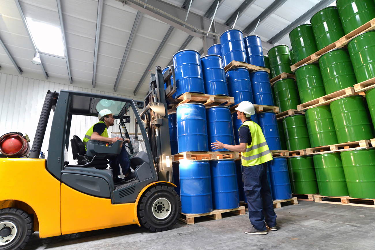 Employees in the chemical industry controlling stock of chemicals and preparing it for shipping.