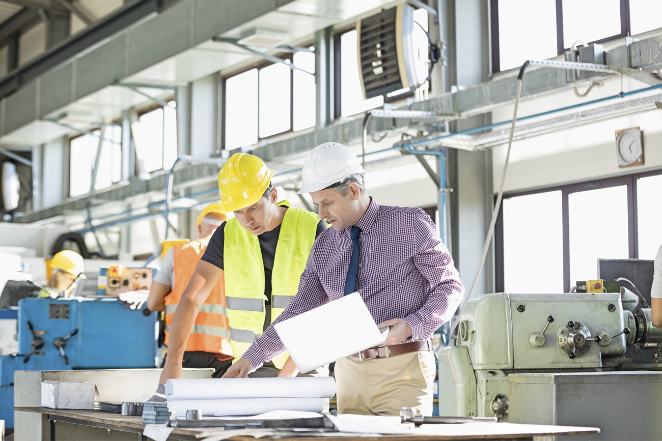 Machinery workers identifying areas that the business requires attention by analysing operational data.