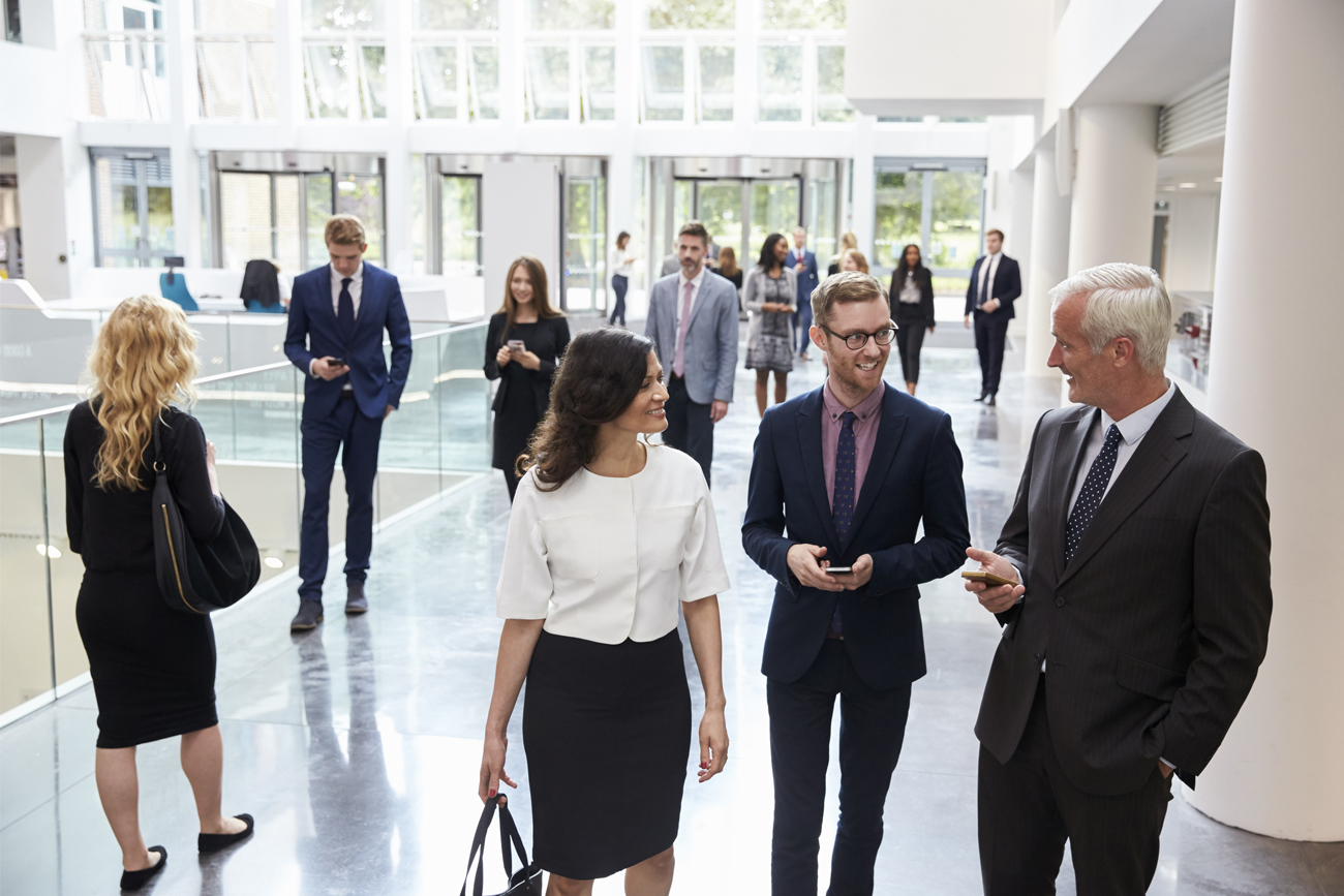 Employees from a large business heading into work discussing ERP solutions.