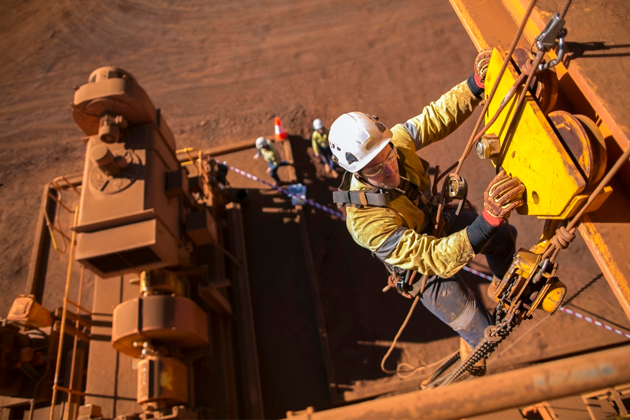 A Mining worker is safely executing his role, having Predictive Maintenance in place to ensure the stability of equipment.