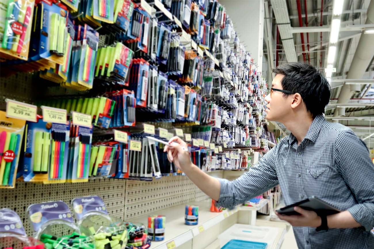 Worker checking stock on hand to see what quantity is required to be ordered.