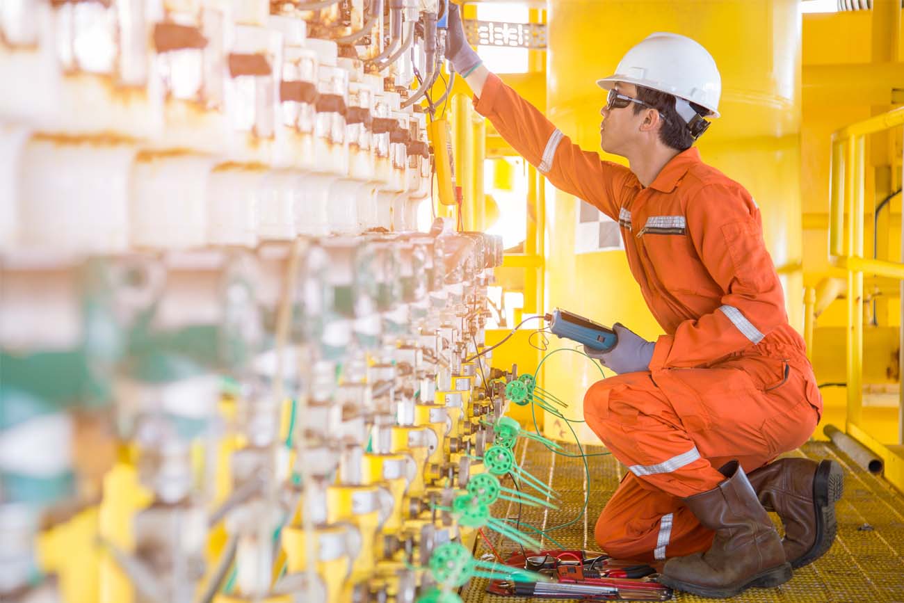 Gas worker checking quality and standards in order to pass quality tests and be issued with a Certificate of Analysis.
