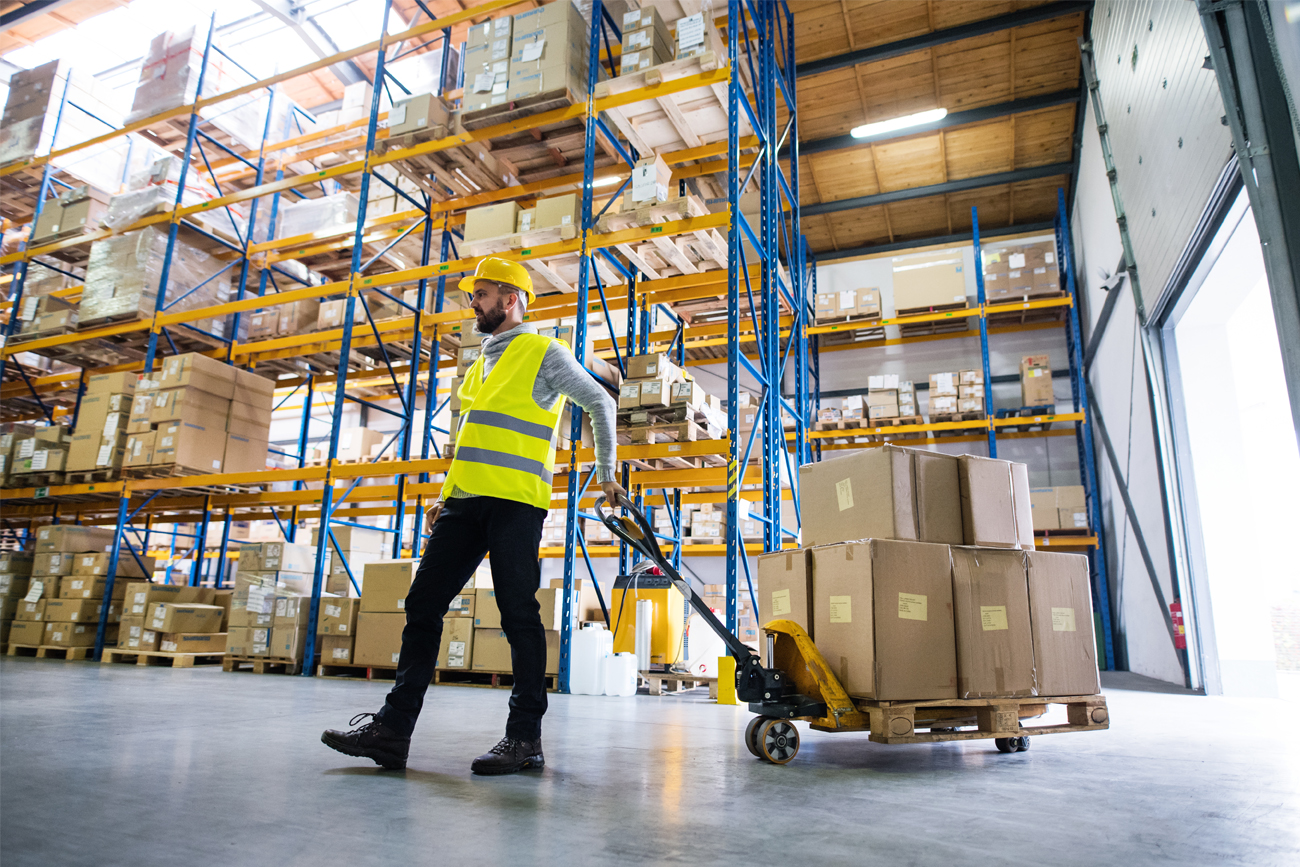Warehouse working preparing stock for transportation.